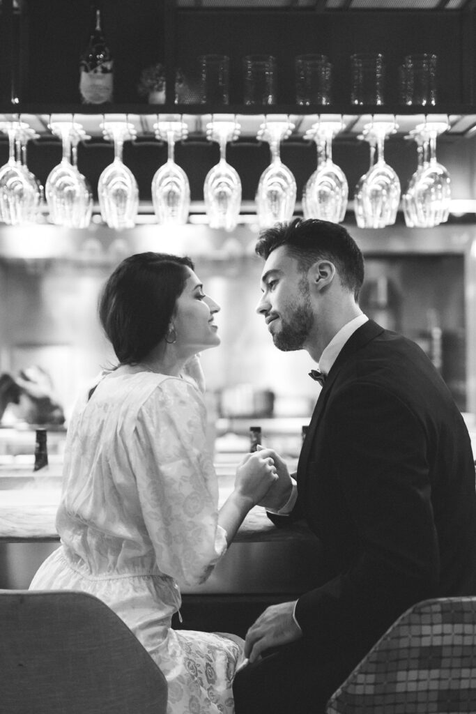 young-man-holding-hands-with-woman-sitting-bar-counter (1)